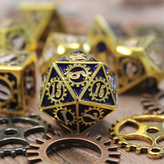 Detail view of the d20 presenting the 5 face of the die on a wooden surface surrounded by cogs and other dice from the set in the background.