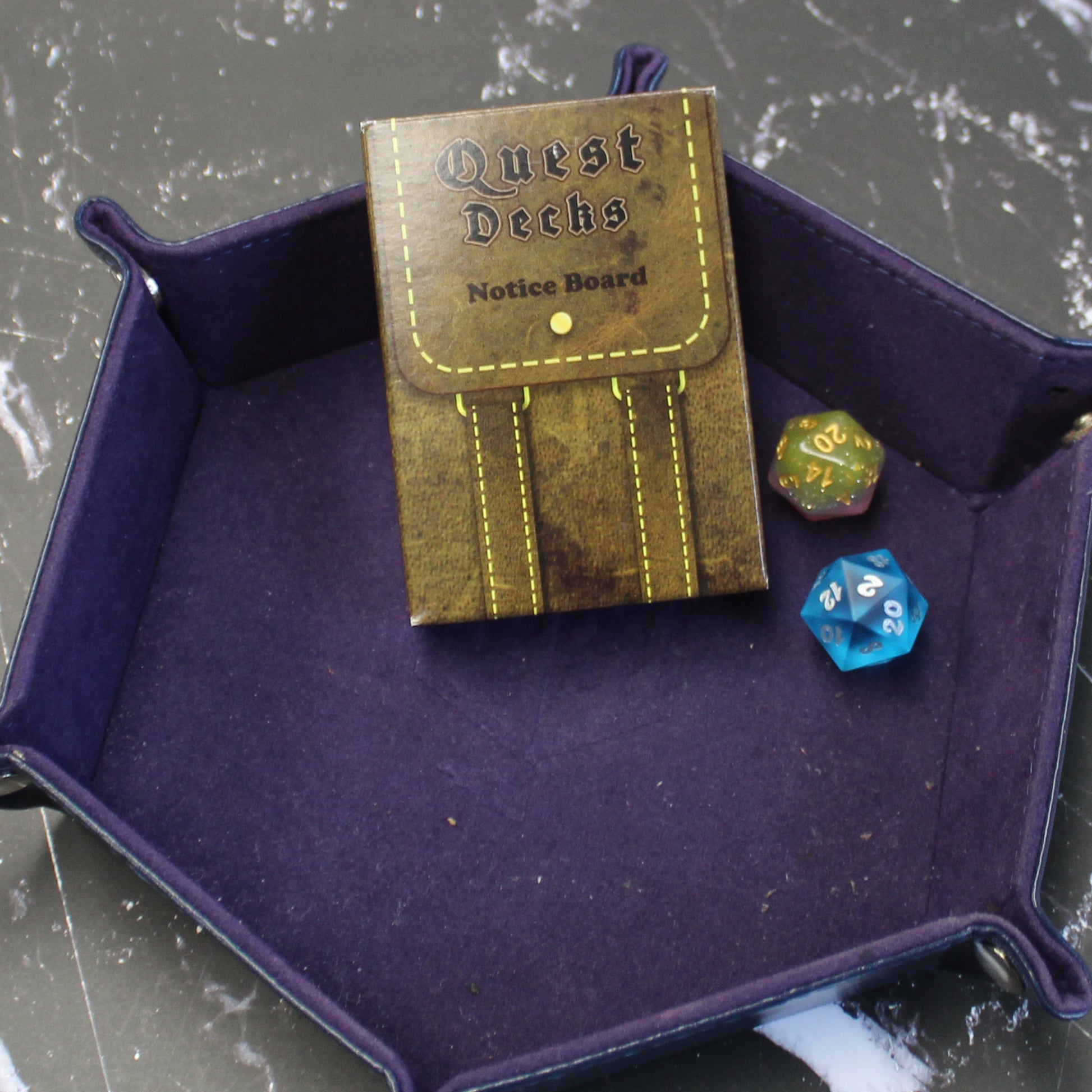 Quest Deck: The Notice Board tuck box in a rolling tray, this box holds 45 quest prompts designed as posted notices from bustling cities and quiet villages.