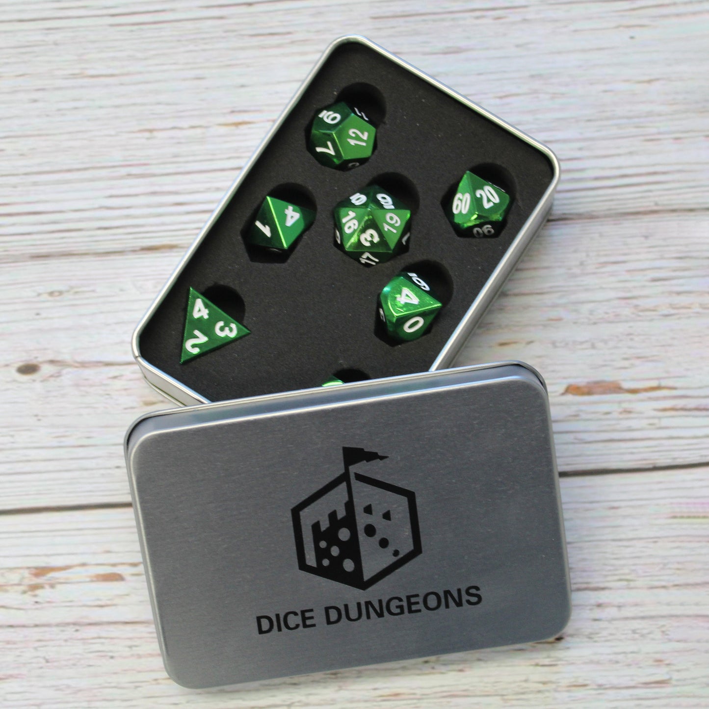 Bright green metal dice in display case box.