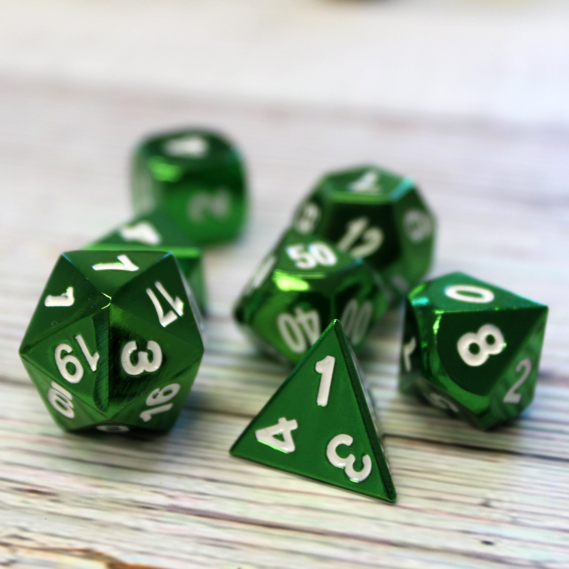 Closup of metal bright green dice set for D&D.