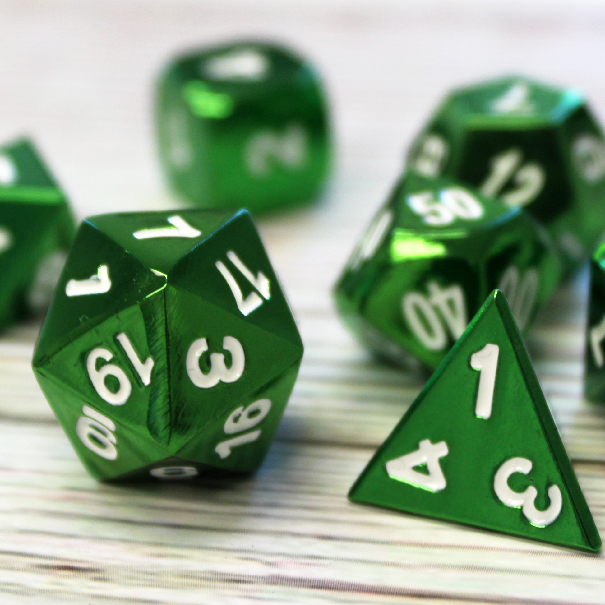 Bright green electroplated dice with white numbering. Dungeons and Dragons dice.