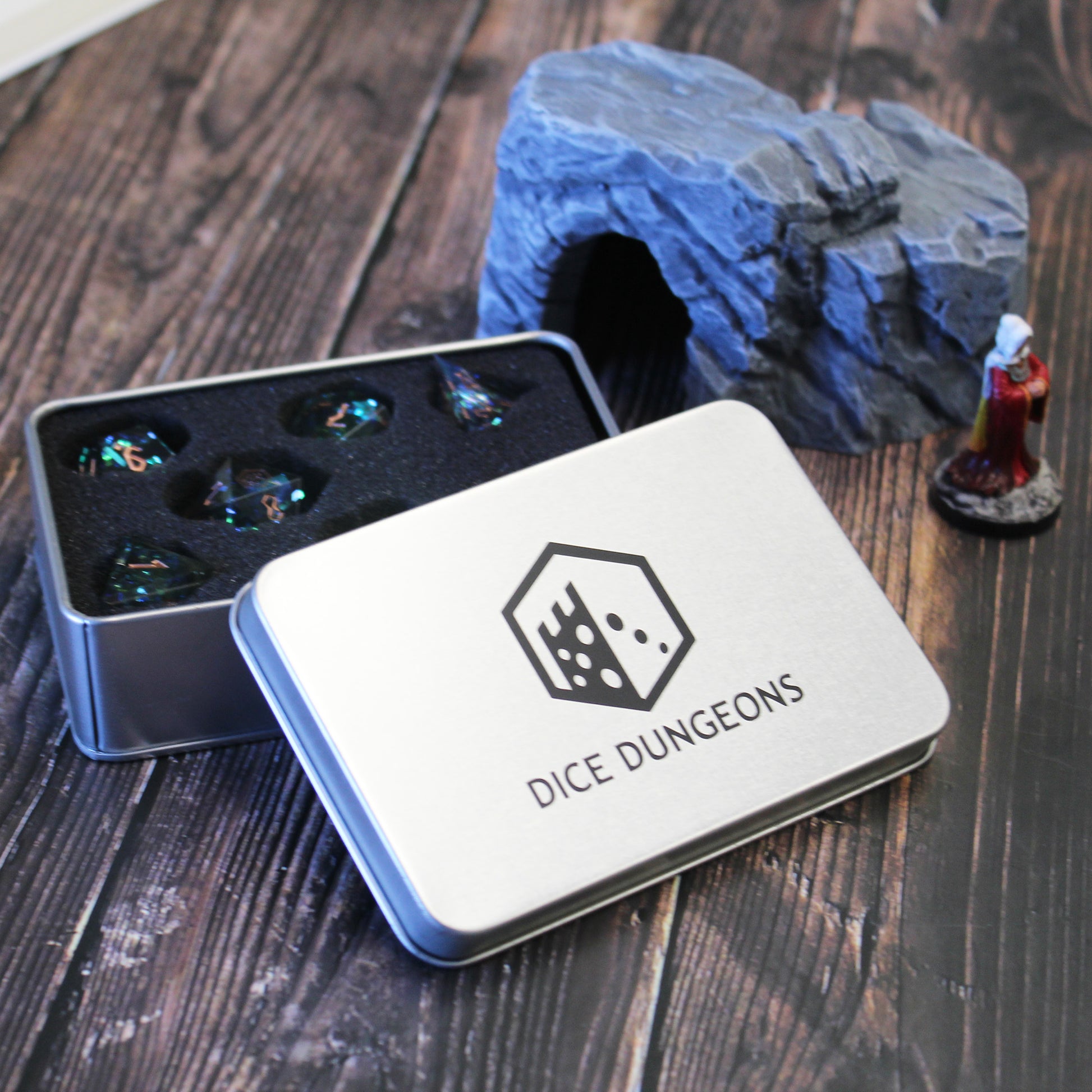 StarGlow Smoke dice set inside the box, ready for a game, featuring glowing iridescent inclusions and sharp edges.