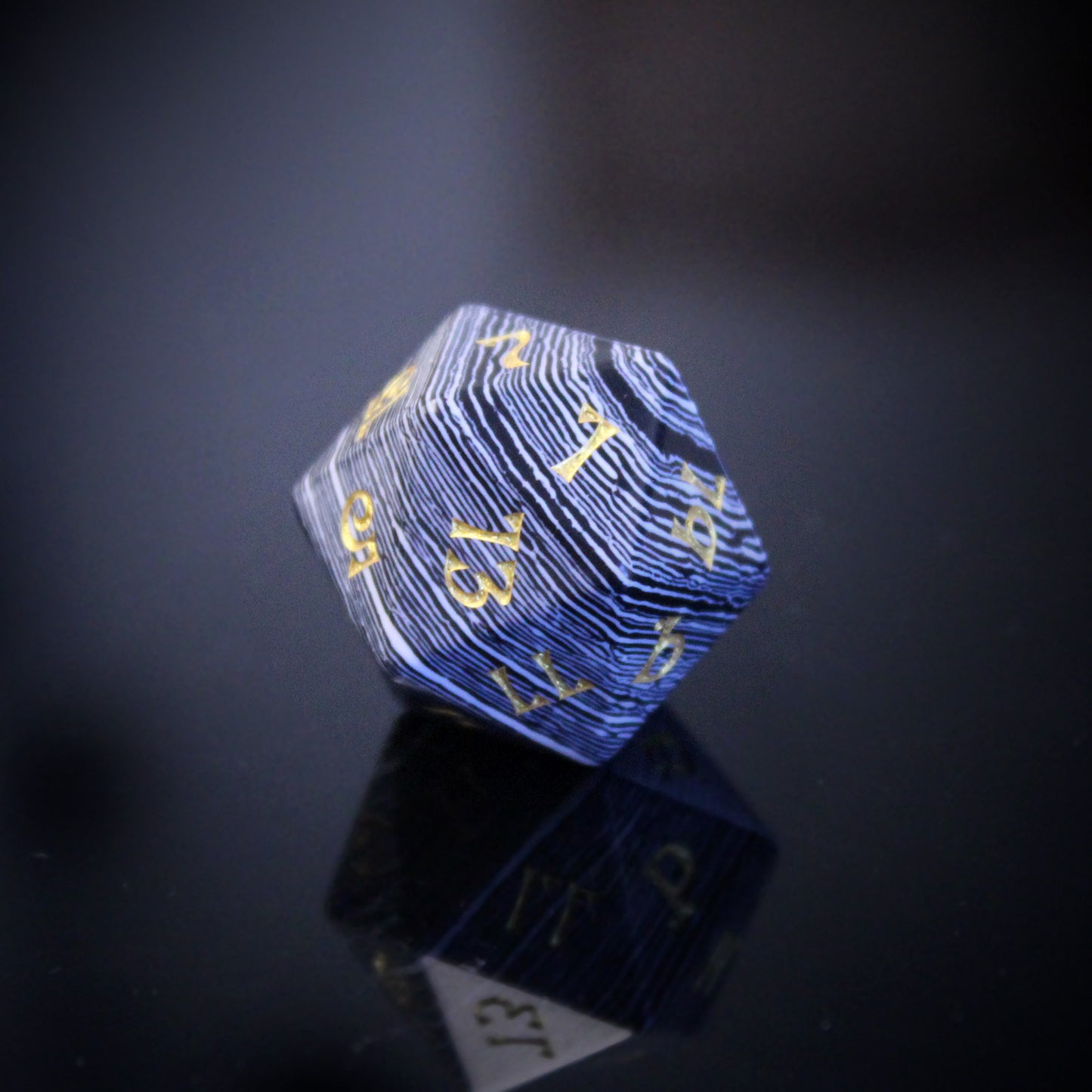 Black and White Striped 20-sided Die with Gold Numbering on a Mirrored Background