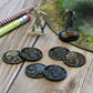 Six Skeleton and Zombie Tokens, with Heads and Tails Sides Showing, Pictured Next to Mini Figures.