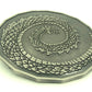 2in dragon coin on white background.  Curled tail on side facing up.