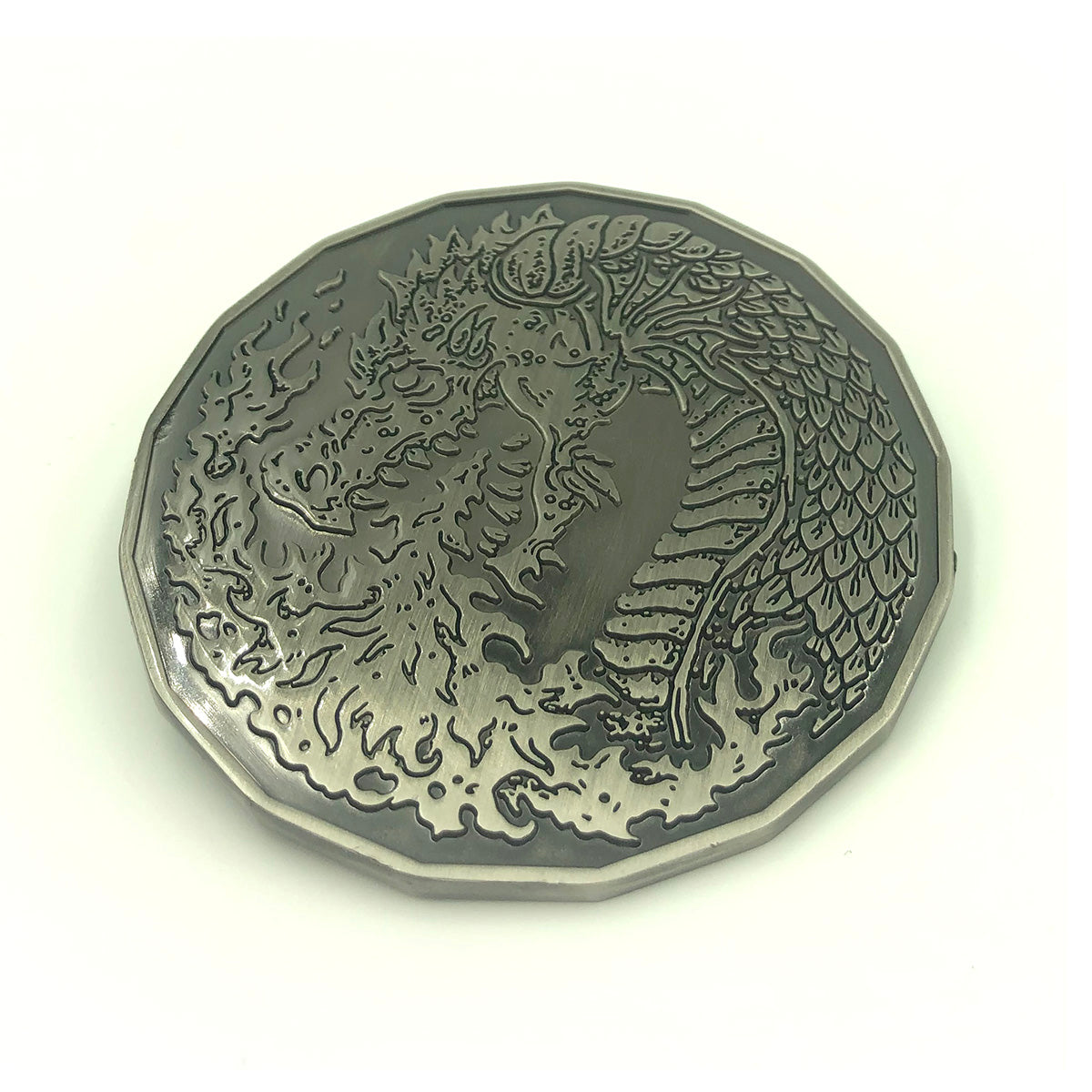 2in Dragon coin on white background.  Dragon breathing fire on side facing up.