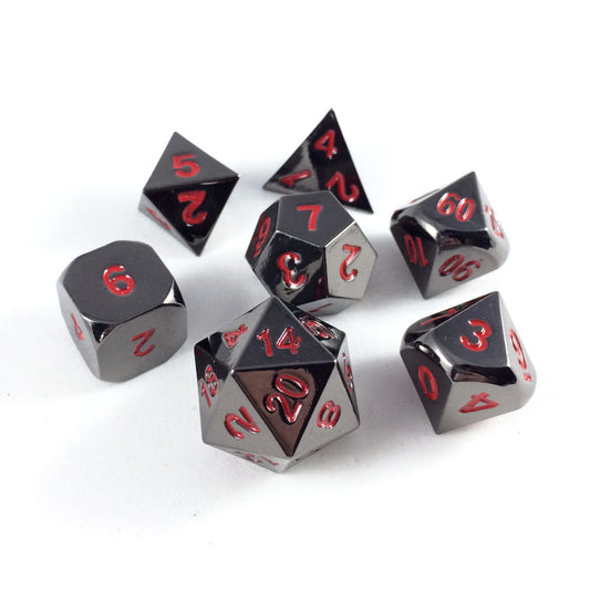 Metal Black Ember dice set scattered on a white background